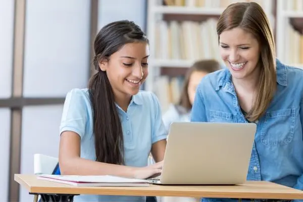 A tutor assisting a student complete her homework