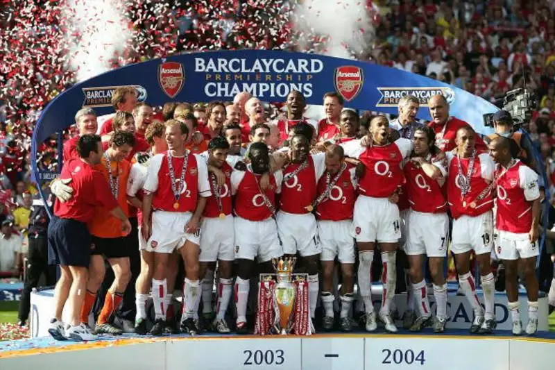 Arsenal celebrating their notable invincibles Premier League victory in the 2003-2004 season. Arsenal is the only team that won the EPL without a single loss (26W 12D 0L).