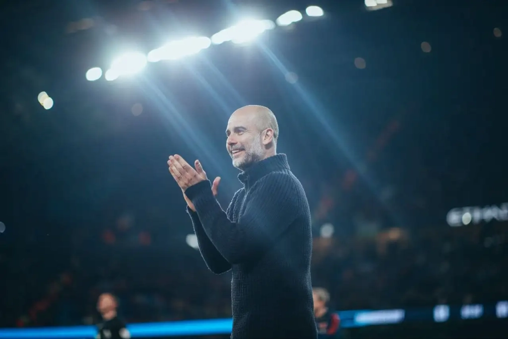 Pep Guardiola celebrating his sides victory over Arsenal in a crucial league match.