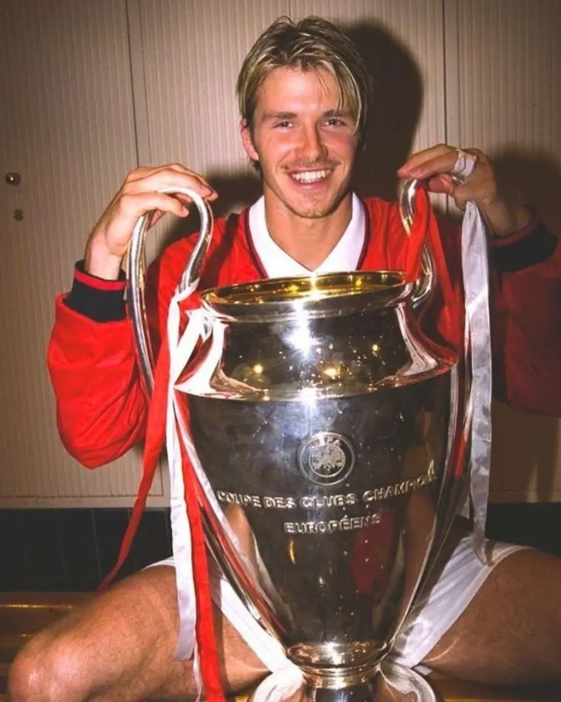 David Beckham holding the Champions League trophy. He setup Teddy Sheringham in the dying seconds of the Champions League final